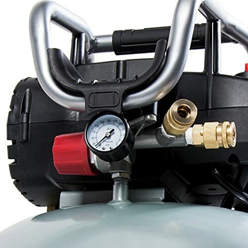 Close-up of an air compressor with gauge and fittings.