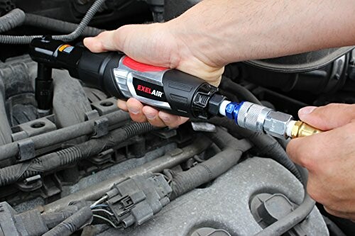 Person using an air ratchet wrench on a car engine.