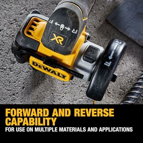 Dewalt drill with forward and reverse capability on textured surface.