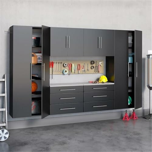 Wall-mounted garage storage cabinet system with tools and equipment.