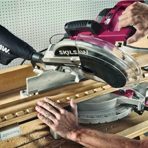 Person using a miter saw to cut wood