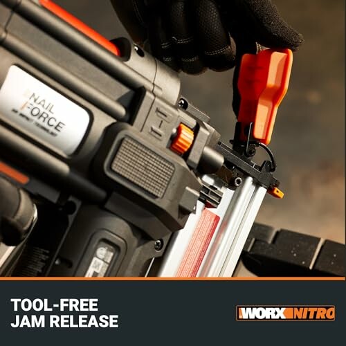 Close-up of a nail gun with tool-free jam release feature.