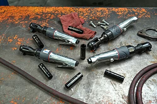 Pneumatic tools and accessories on a workbench.