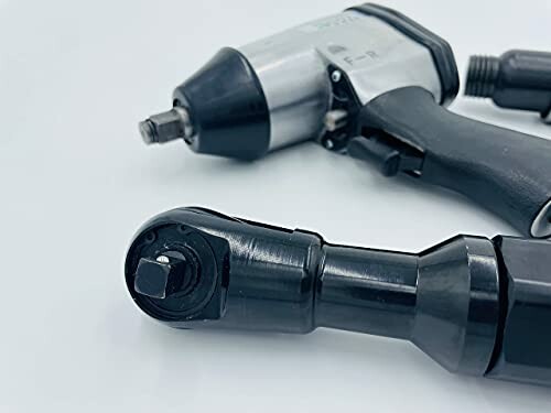 Close-up of pneumatic tools on a white background.