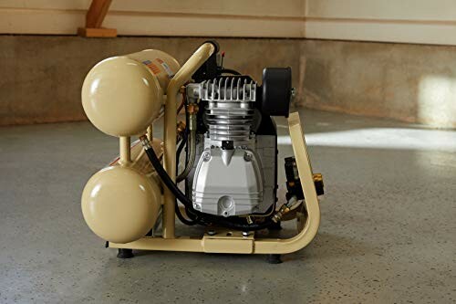 Portable air compressor on a concrete floor.