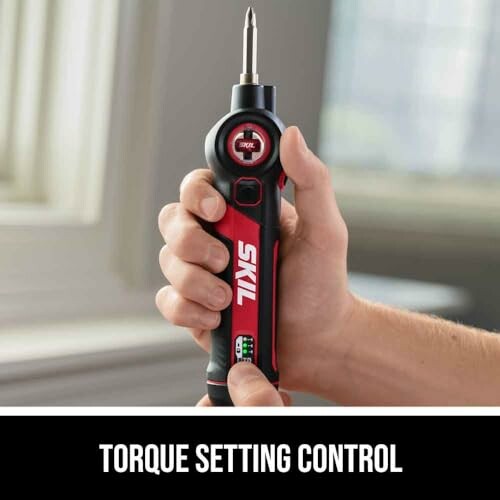 Hand holding SKIL electric screwdriver with torque setting control