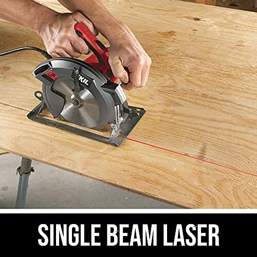 Person using a circular saw with single beam laser on a wooden surface