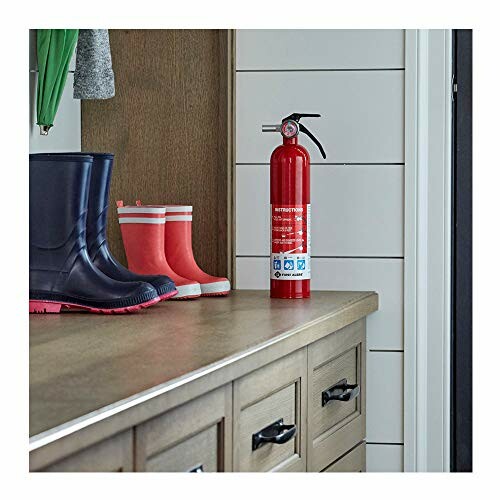 Fire extinguisher and rain boots on a wooden cabinet