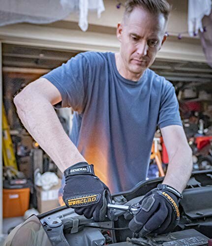 Man working on car engine with tools