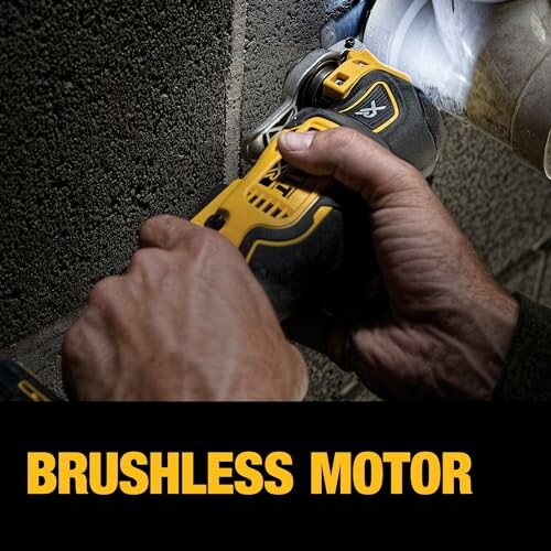 Person using a brushless motor power tool on a wall.